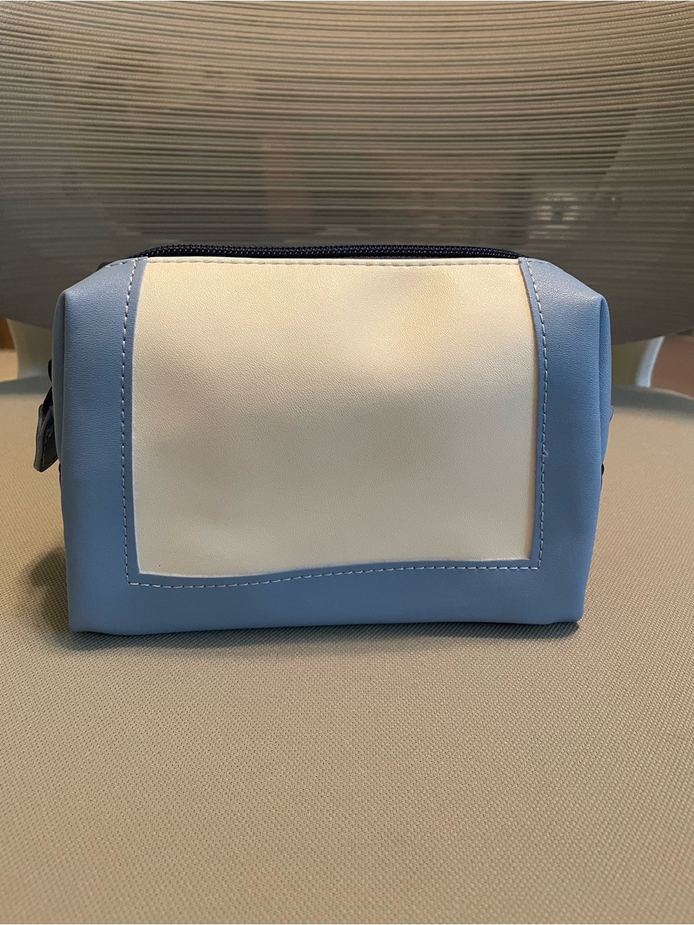Nordstrom blue and white color block faux leather toiletry bag.